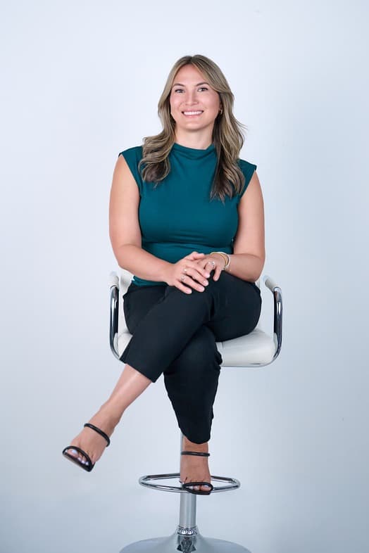 Melissa Ross seated in a studio portrait